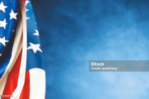 american flag pictured in front of a textured blue background